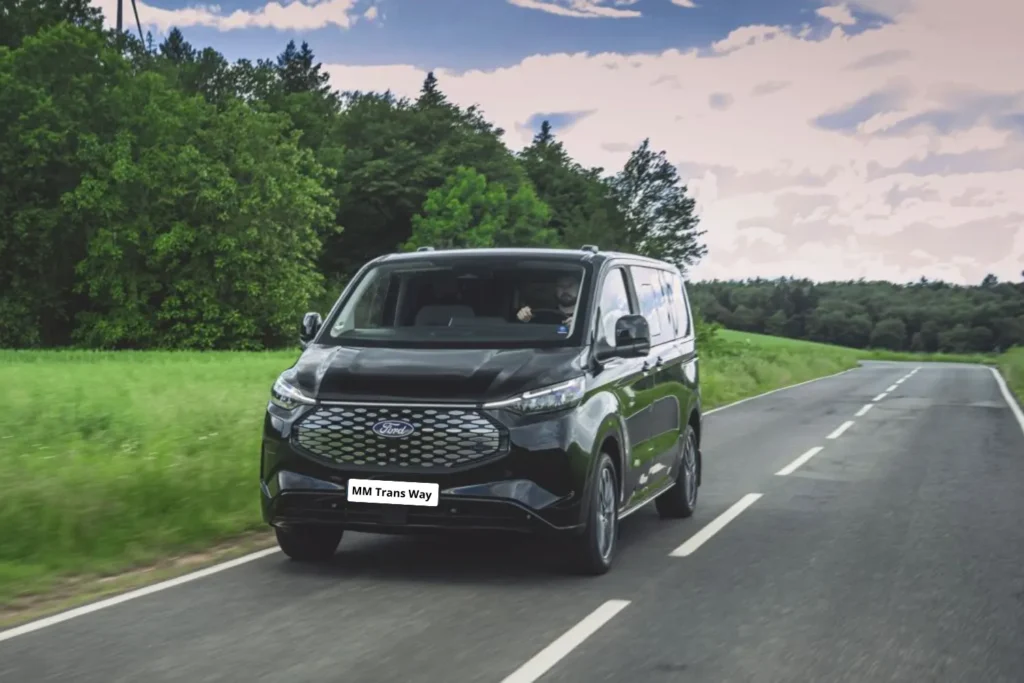 Black Ford Tourneo van driving on rural road
